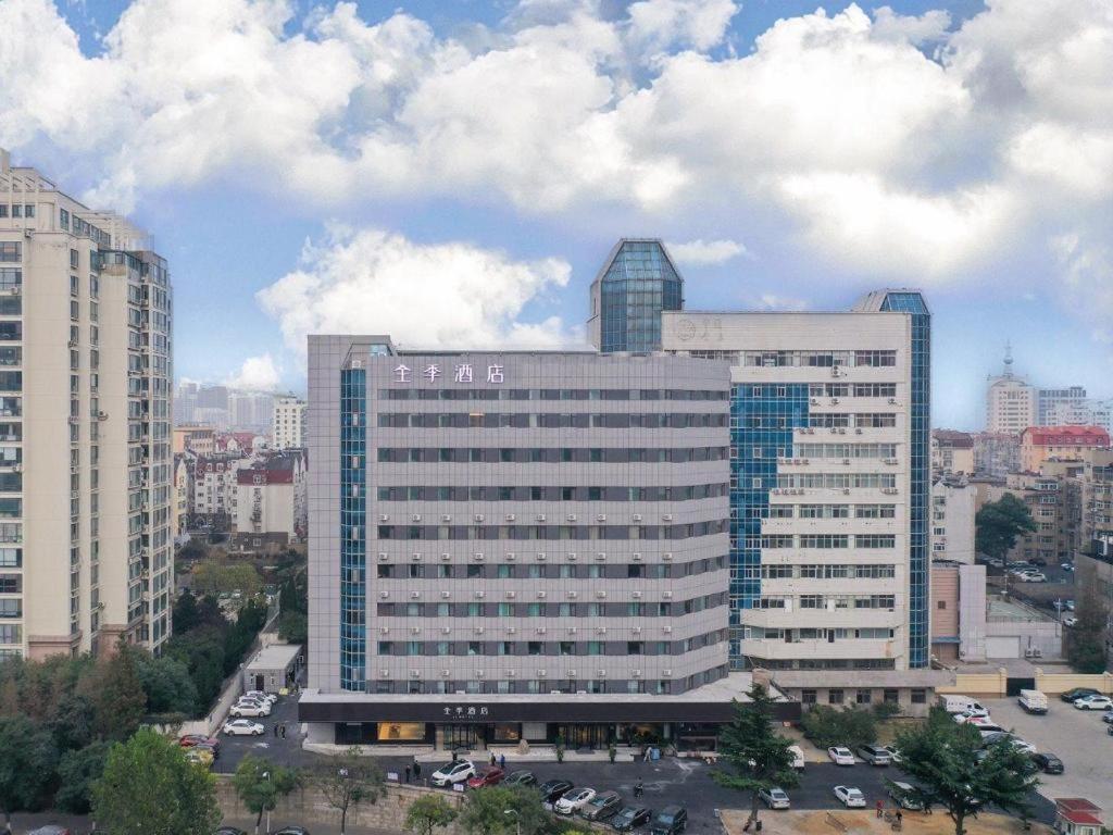 a large office building in a city with buildings at Ji Hotel Qingdao Shandong Road Mixc in Qingdao