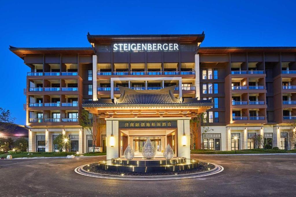 a building with a fountain in front of it at Steigenberger Hotel SUNAC Jinan in Hongjialou