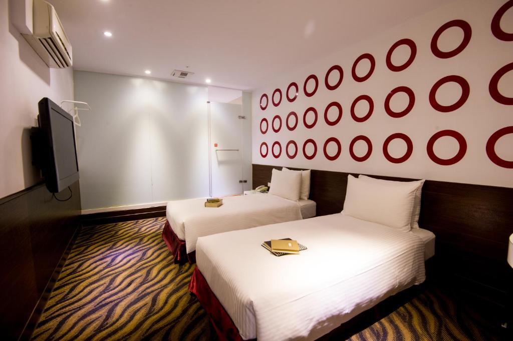 Postel nebo postele na pokoji v ubytování Moshamanla Hotel - Ximen