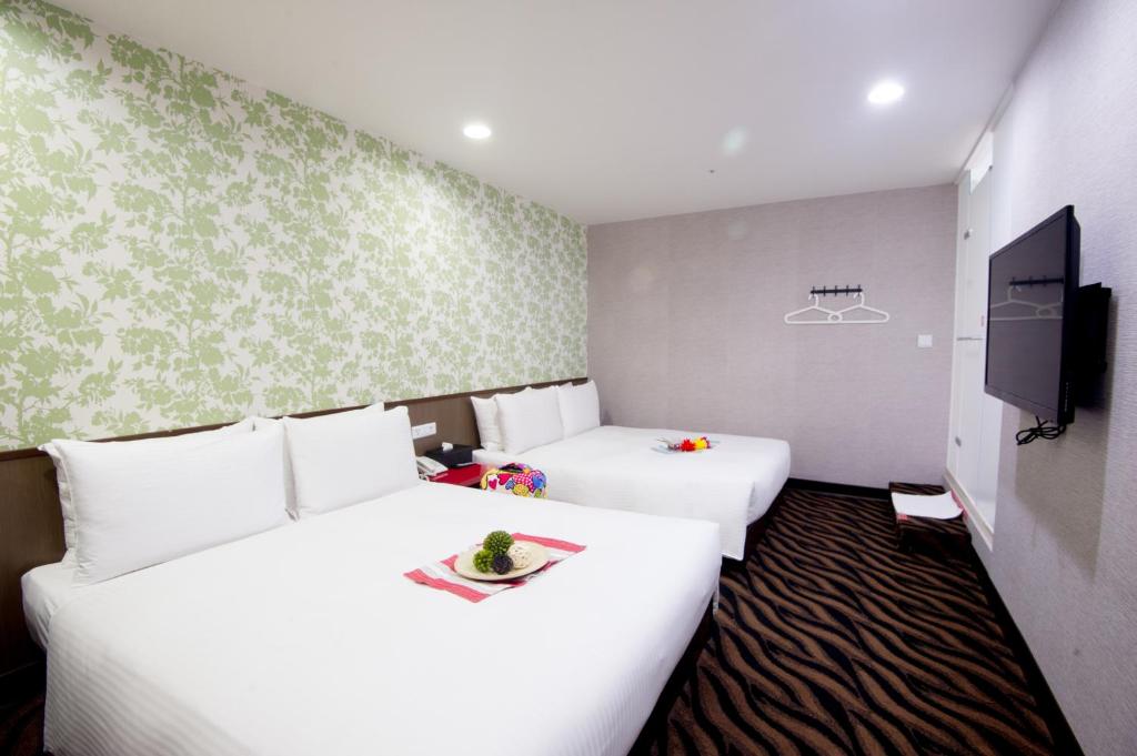 Postel nebo postele na pokoji v ubytování Moshamanla Hotel - Ximen