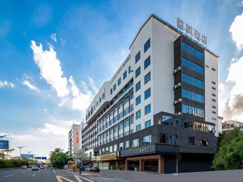 - un grand bâtiment blanc dans une rue de la ville dans l'établissement Lavande Hotel Chaozhou Fortune Center Lin Street, à Chaozhou