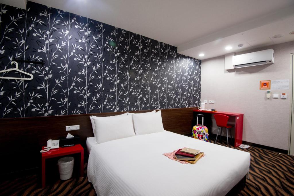 Postel nebo postele na pokoji v ubytování Moshamanla Hotel - Ximen