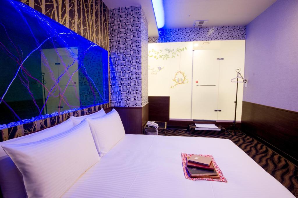 Postel nebo postele na pokoji v ubytování Moshamanla Hotel - Ximen