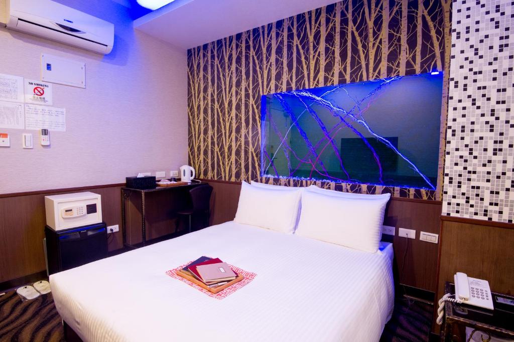 Postel nebo postele na pokoji v ubytování Moshamanla Hotel - Ximen