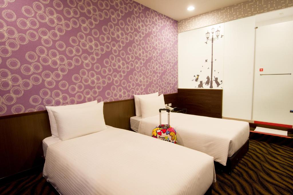 Postel nebo postele na pokoji v ubytování Moshamanla Hotel - Ximen