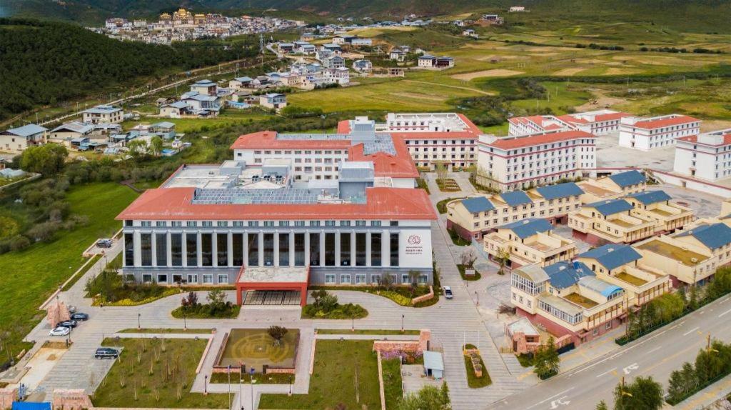 an aerial view of a city with a large building at Tanshan Hotel in Shangri-La