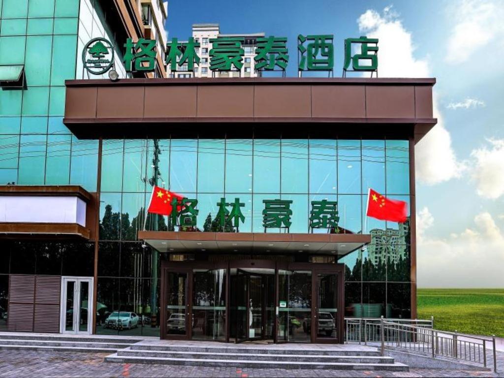 a building with chairs and flags on top of it at Green Tree Inn Hebei Cangzhou Hejian Middle Shijing Road in Xiguan