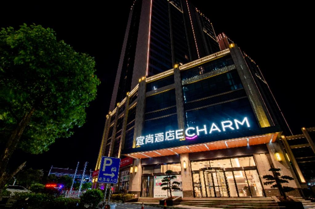 a building with a sign on the side of it at Echarm Hotel Wuhu Pedestrian Street High-speed Railway Station in Wuhu