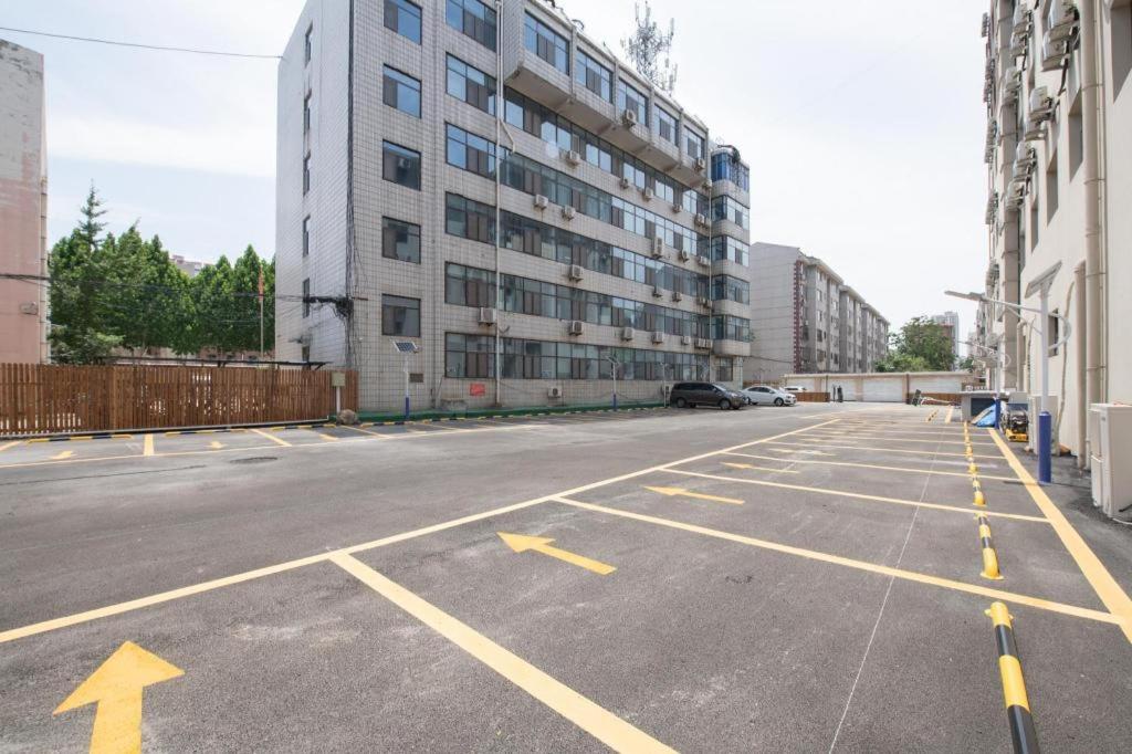 an empty parking lot with a large building at JI Hotel Zibo Renmin West Road in Zibo