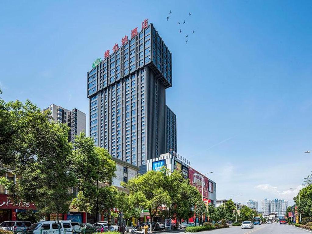 a tall building with birds on the top of it at Vienna Hotel Shaanxi Hanzhong Central Square High-Speed Railway Station in Hanzhong