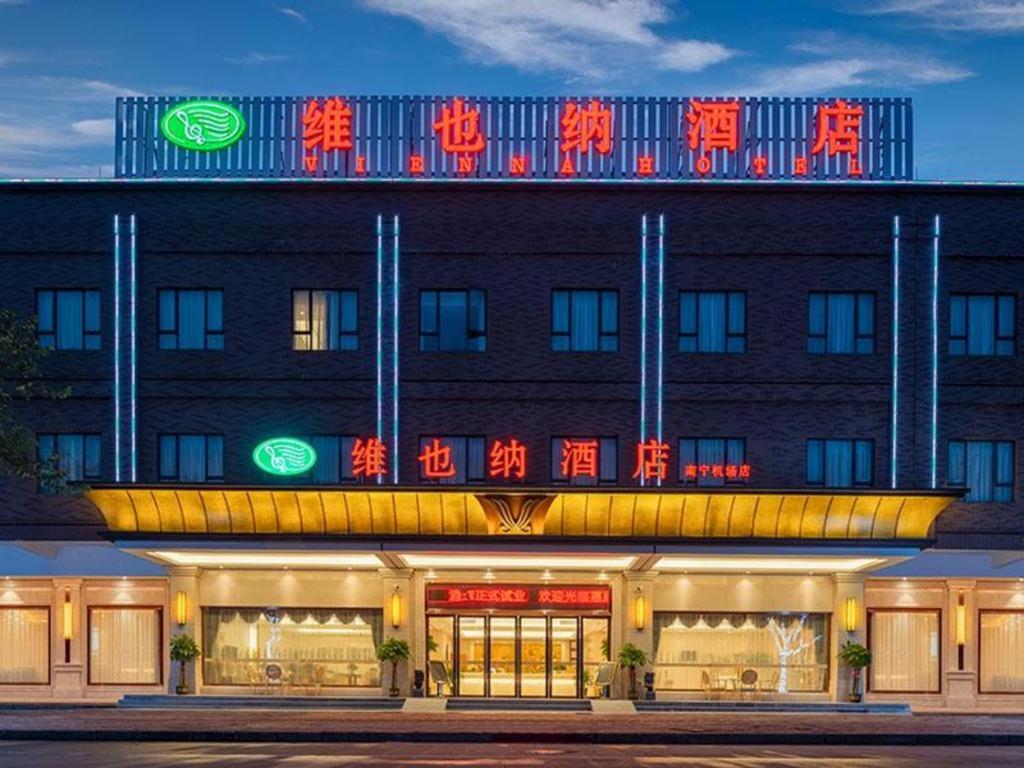 a building with neon signs on the front of it at Vienna Hotel Nanning Airport in Tanbai