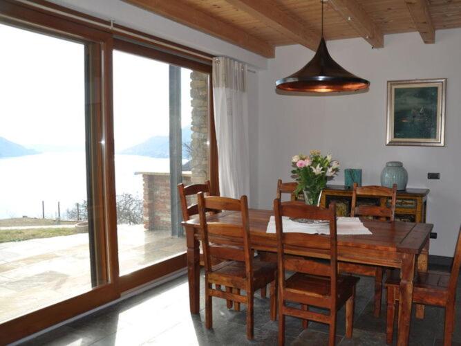 a dining room with a wooden table and chairs at Apartment in Maccagno con Pino e Vedascca in Maccagno Inferiore