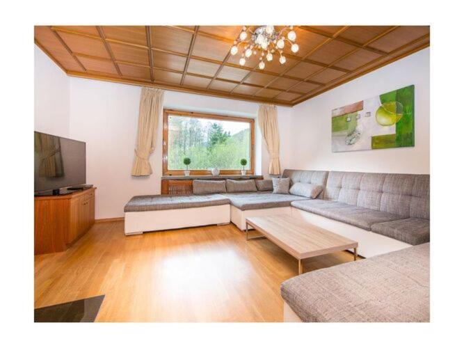 a living room with a couch and a table at Holiday home Landhaus Prielau in Maishofen