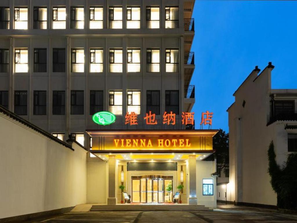 a building with a sign that reads venanza hotel at Vienna Hotel Wuhan Guobo Jiangang Metro Station in Han-yang-hsien