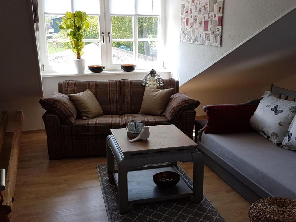 a living room with a couch and a table at Apartment in Rieseby in Rieseby