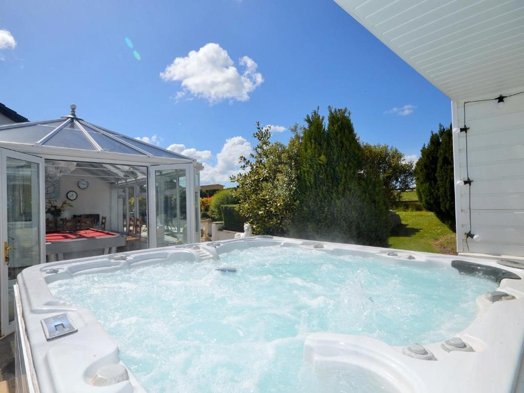 a jacuzzi tub in a backyard at 6 Bed in Buckland Brewer SWOLD in Buckland Brewer