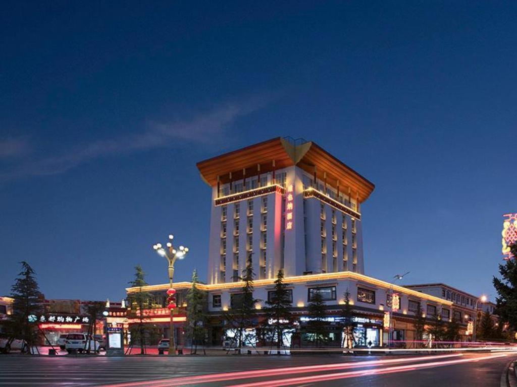 a large building with lights on it at night at Vienna Hotel Yunnan Shangri-La Ancient City in Shangri-La