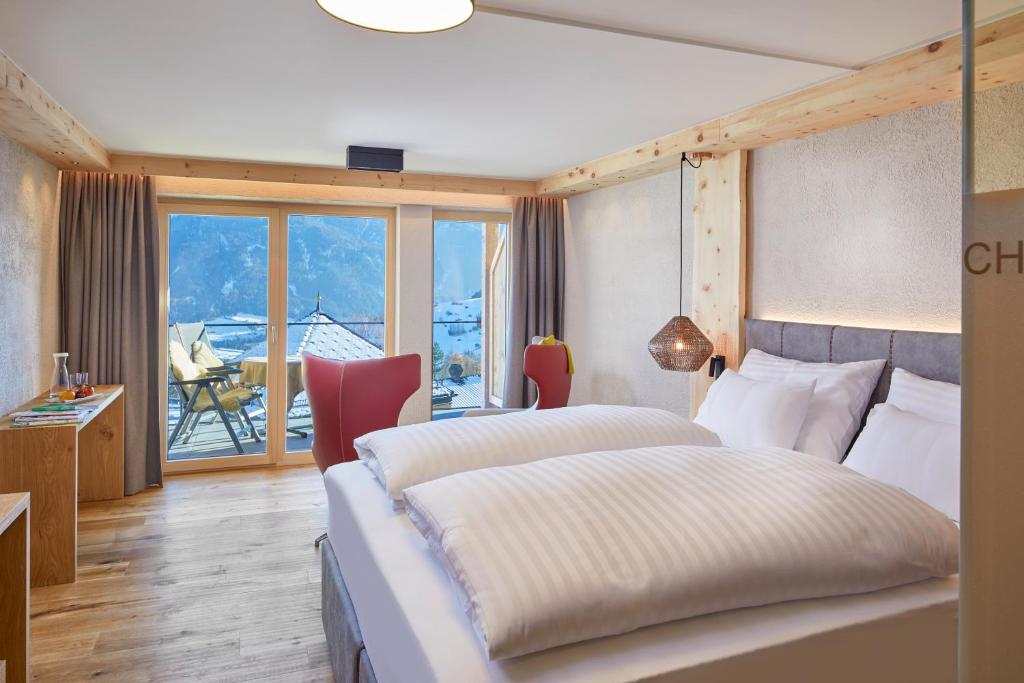 Ένα ή περισσότερα κρεβάτια σε δωμάτιο στο Hotel Tirol Fiss 4Sterne Superior