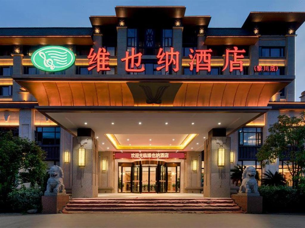 ein Gebäude mit einem Schild davor in der Unterkunft Vienna Hotel Jiangxi Fuzhou Lichuan Kangshu in Lichuan