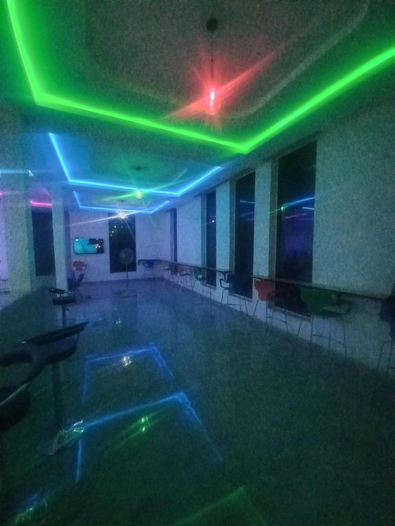 an empty swimming pool with green and blue lights at JF Royal Hotel & Suites in Ogbomoso