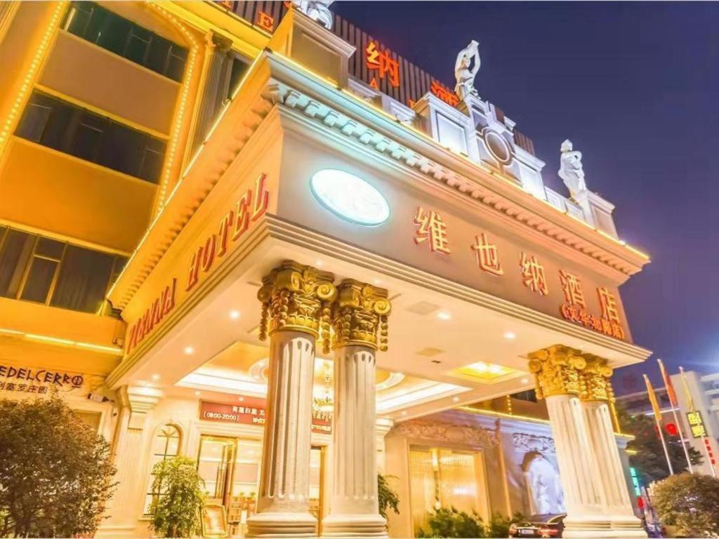 a building with a sign on the front of it at Vienna Hotel Guangdong Foshan Wenhua North Road in Nanhai