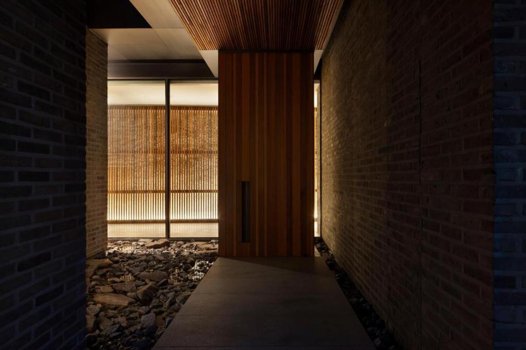 a hallway with a brick wall and a window at Namu Hotel in Seoul