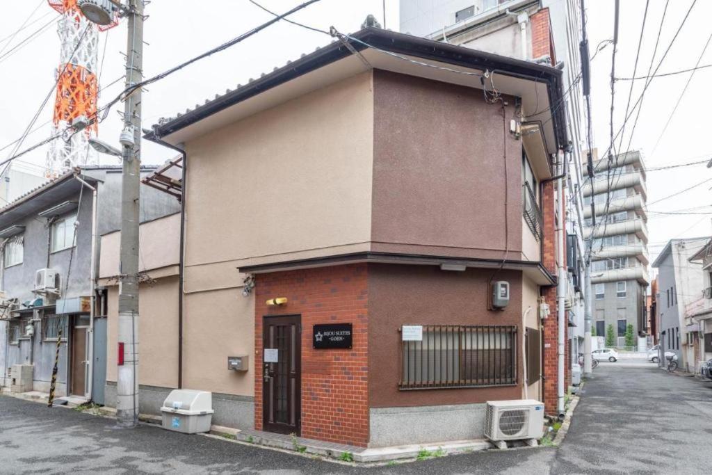 a small building on the side of a street at Bijou Suites Goen in Osaka