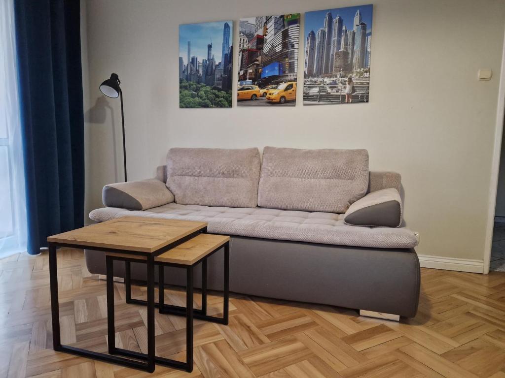 a living room with a couch and a table at Apartament na Błoniach in Sanok