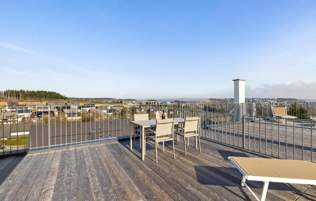a balcony with a table and chairs on a deck at Sonnendeck in Winterberg