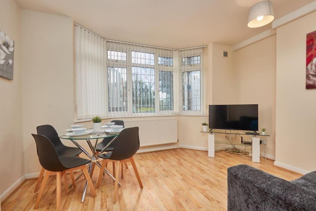 a living room with a table and chairs and a tv at Cosy Corner on Burton Road in Derby