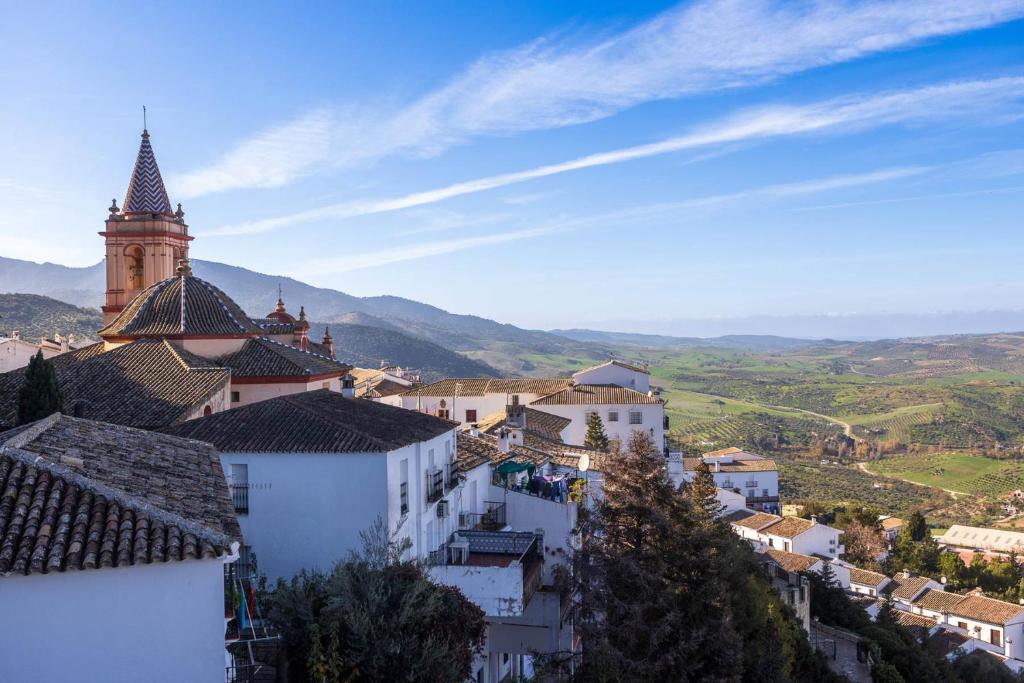 a view of a town with a clock tower at Hotel Tugasa Arco de la Villa in Zahara de la Sierra