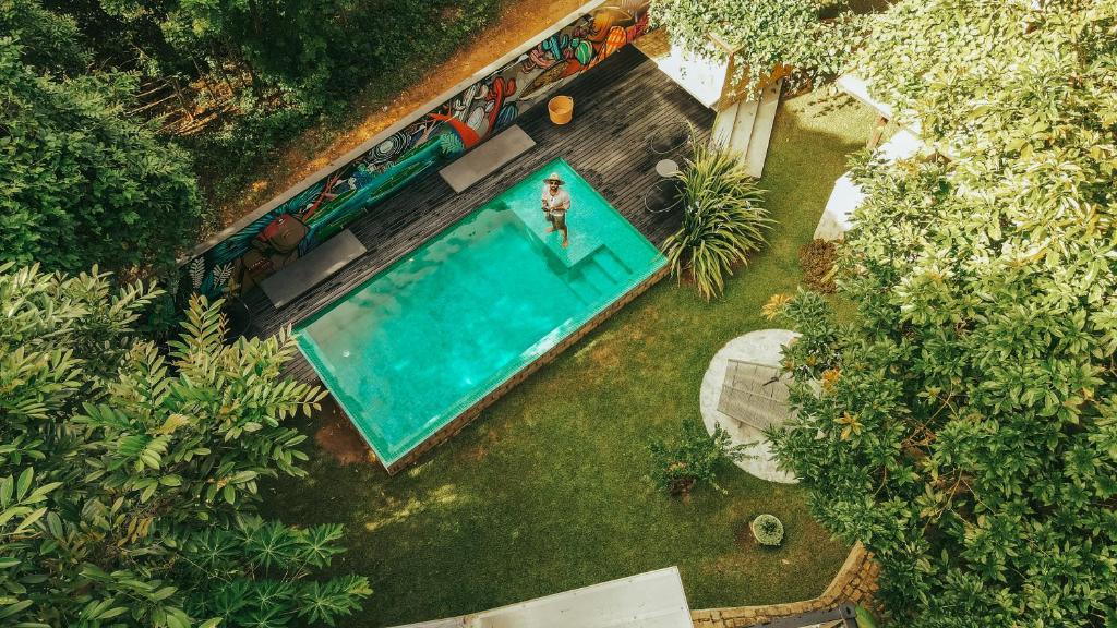 an overhead view of a person in a swimming pool at Casa Antônia - Pousada Boutique in Lençóis
