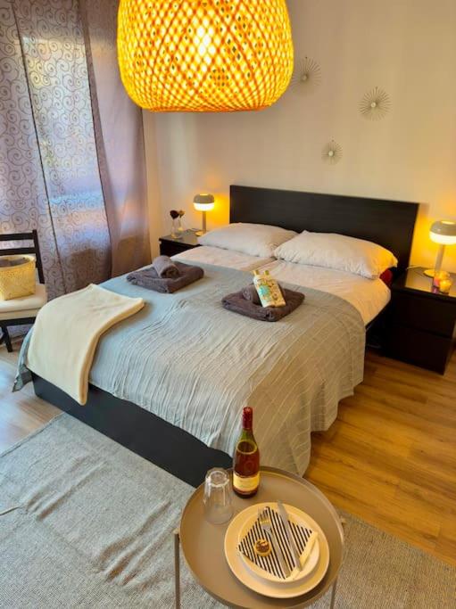 a bedroom with two beds and a table with a bottle on it at Südstadtoase • Tübingen &freeParking in Tübingen