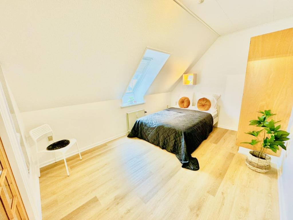 a bedroom with a bed and a window at aday - Stylish Central Apartment in Hjorring in Hjørring