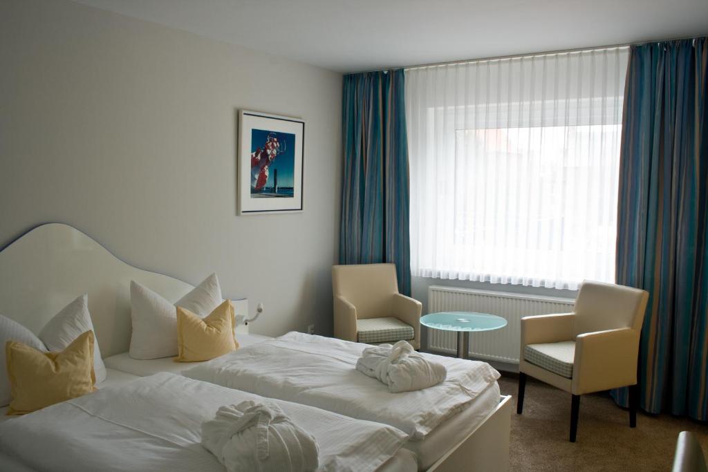 Postel nebo postele na pokoji v ubytování Frühstückshotel Seemannsbraut Amrum-adults only ab 18 Jahre-keine Haustiere-
