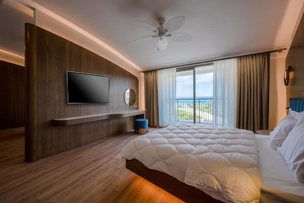 a bedroom with a bed and a television on a wall at Star Boutique Hotel in Antalya