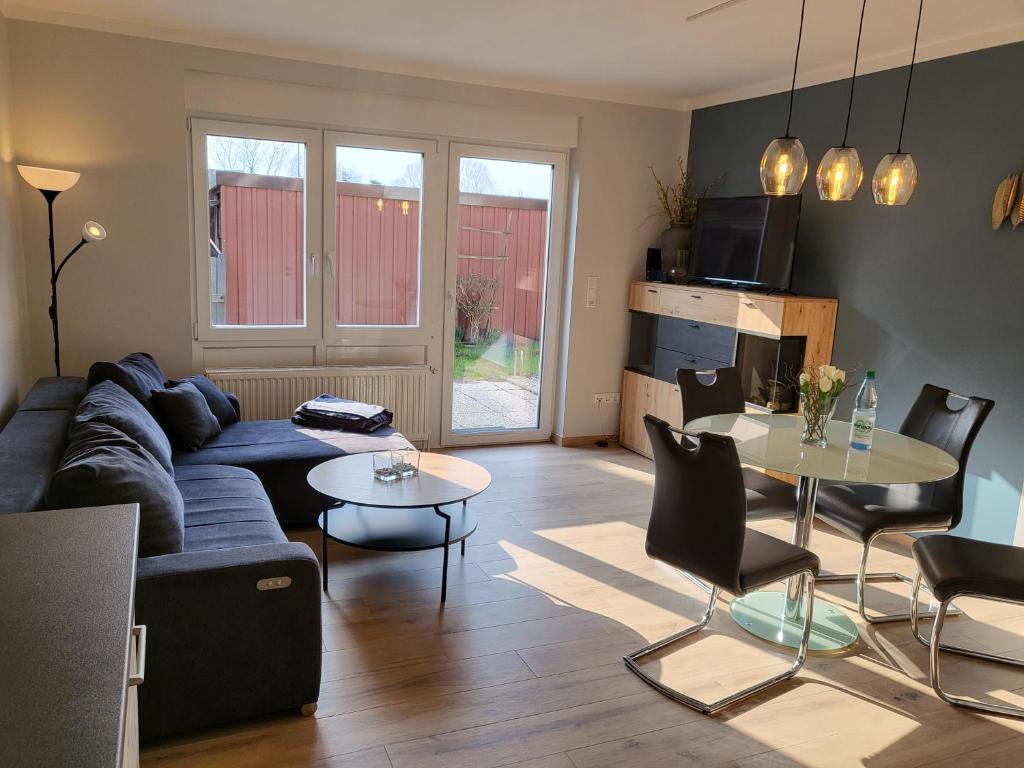 a living room with a couch and a table at FeWo Poststr. 9 Norddeich in Norddeich