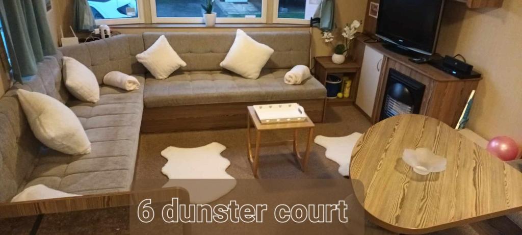 a living room with a couch and a table at 3 bed static 12ft caravan home from home somerset in Watchet