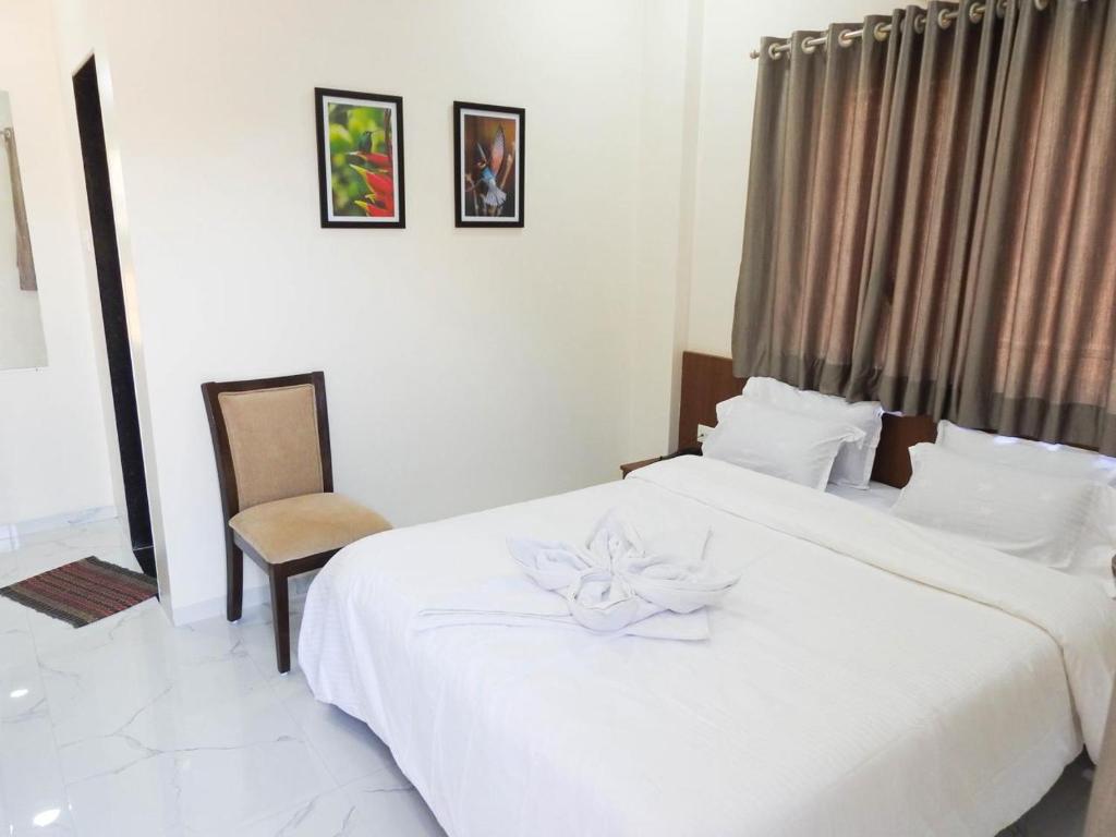 Postel nebo postele na pokoji v ubytování Hotel Sai Sneha