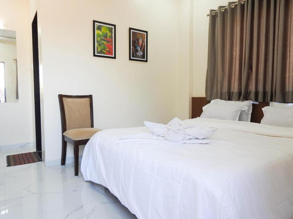Postel nebo postele na pokoji v ubytování Hotel Sai Sneha