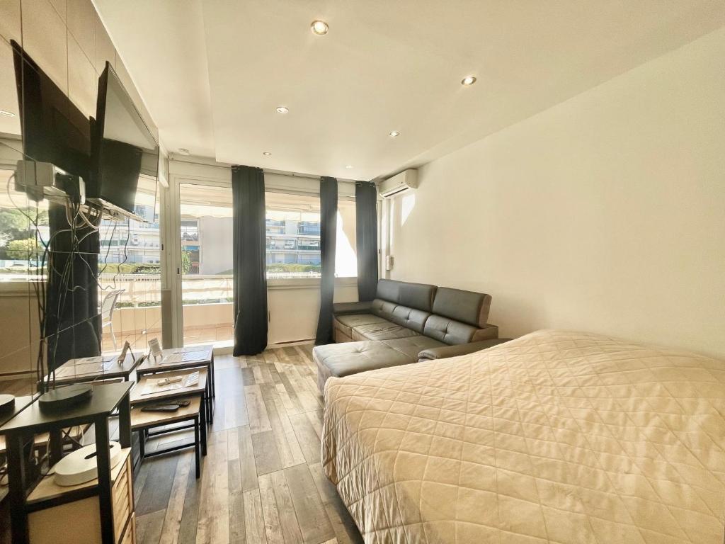 1 dormitorio con cama, sofá y TV en Palm Paradise, by Welcome to Cannes en Cannes