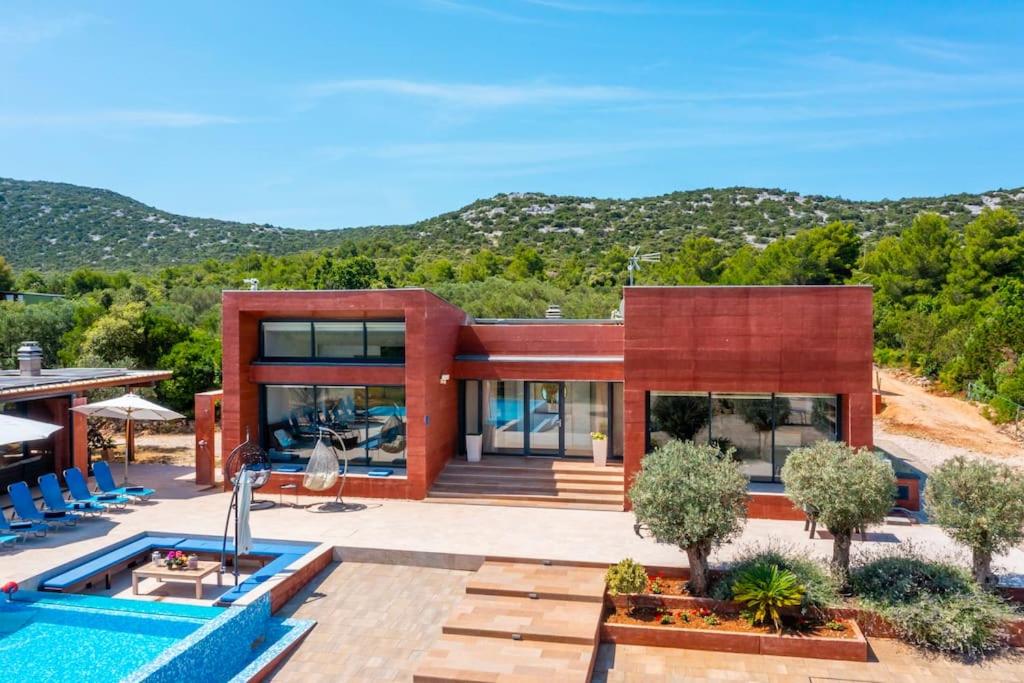 una casa con una piscina di fronte di Modern Luxurious Villa with SPA-Adria Resort a Tisno (Stretto)