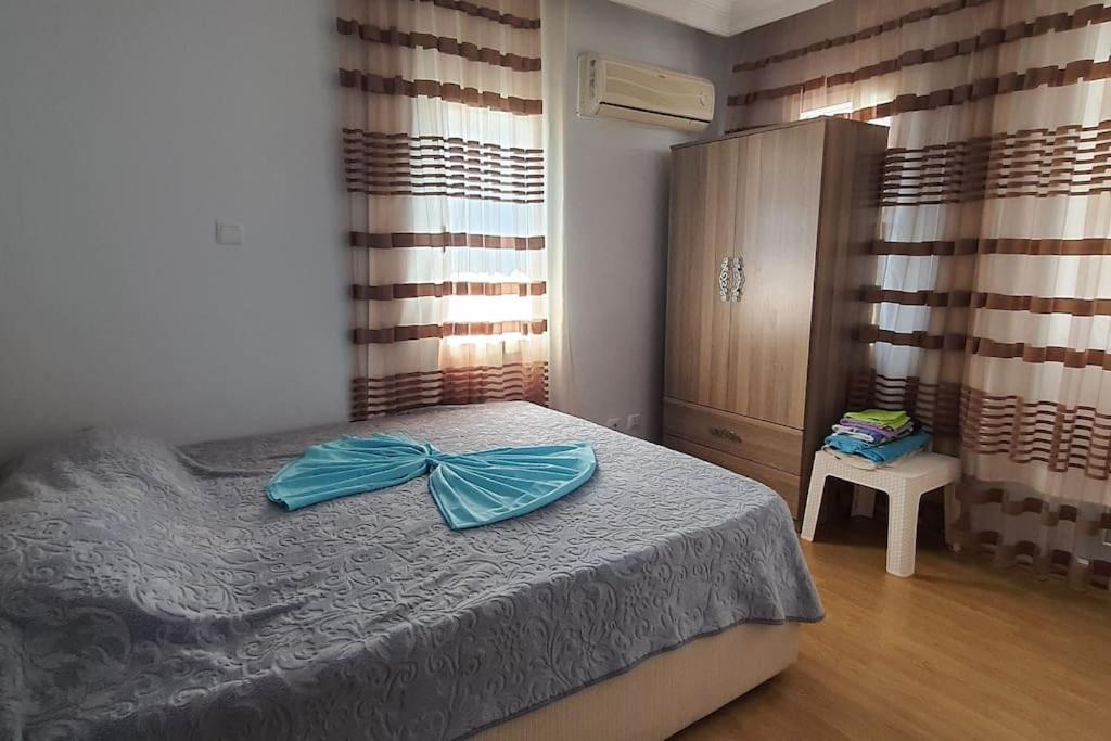 a bedroom with a bed with a blue bow on it at VİLLA KEYF in Side