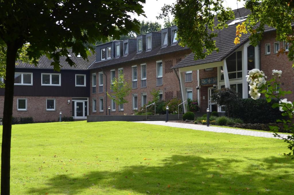 a large brick building with a lawn in front of it at Haus Mariengrund in Münster