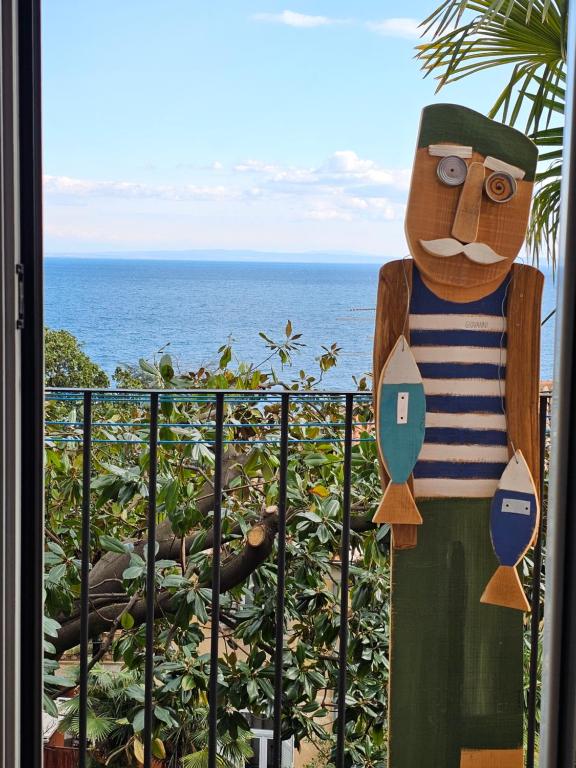 a statue of a man standing in front of a balcony at Sunny apartment 150 m from the sea in Opatija