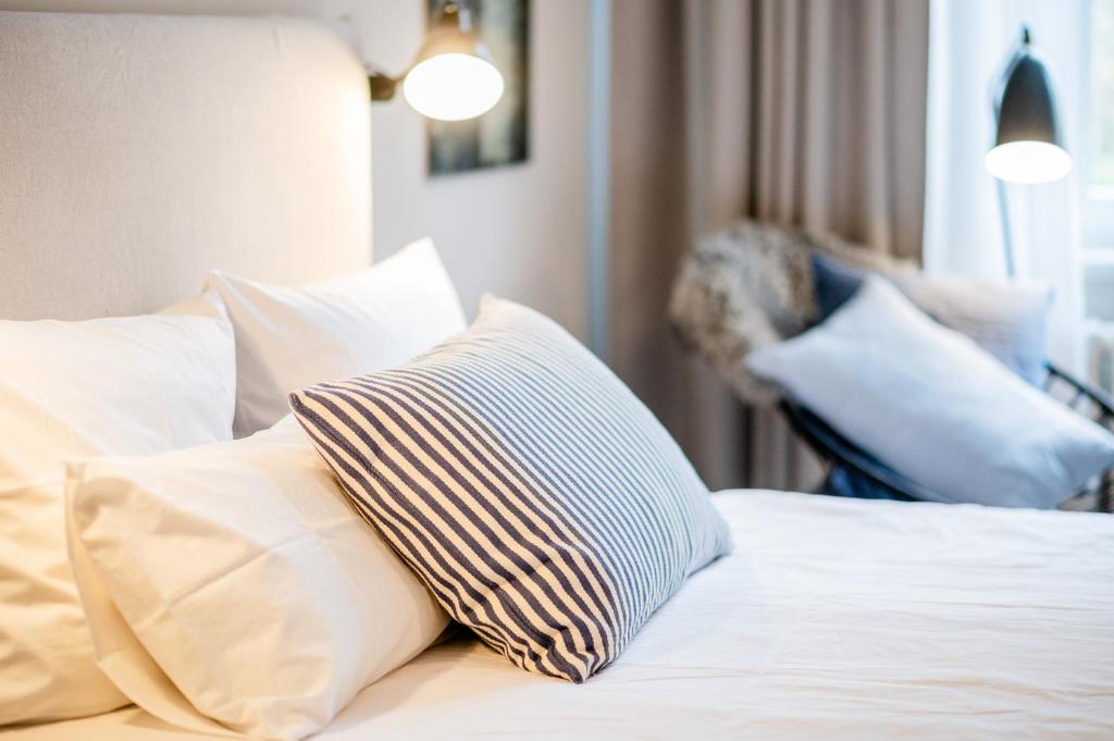 Postel nebo postele na pokoji v ubytování Aarskogs Boutique Hotel