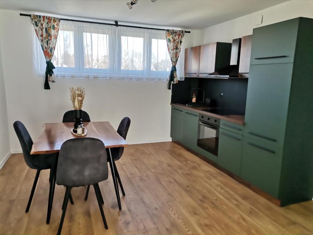 a kitchen and dining room with a table and chairs at Studio apartman Daruvar in Daruvar