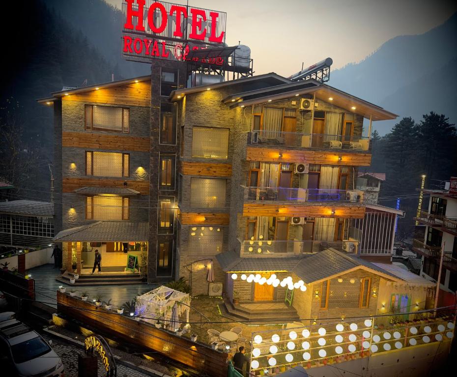 a hotel with a neon sign in front of it at Royal Castle in Kasol