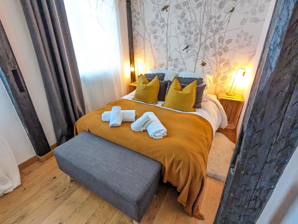a bedroom with a large bed with towels on it at Appartement Place de la Cath' avec Parking in Colmar
