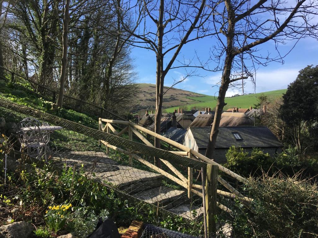 a set of stairs with a wooden fence at Mermaid Cottage in West Lulworth
